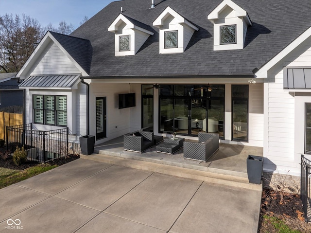 rear view of house with an outdoor living space and a patio area