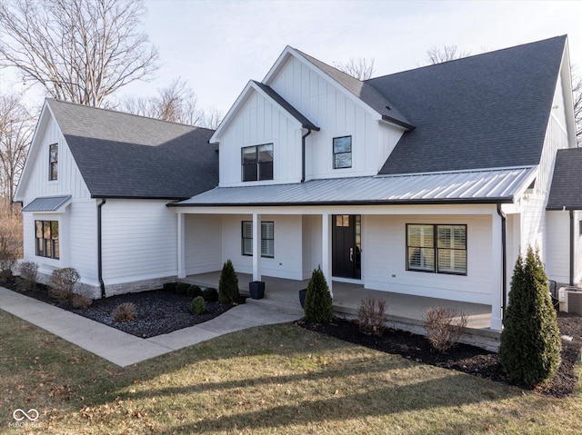 modern inspired farmhouse featuring a front lawn and a porch