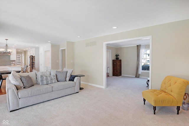 living room with light colored carpet and a notable chandelier