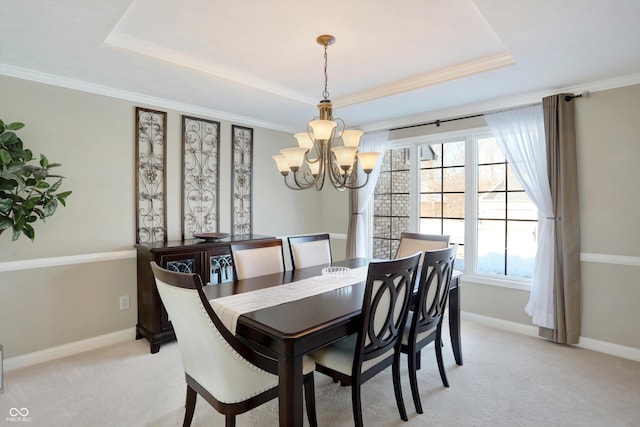 dining area featuring light colored carpet, a raised ceiling, and an inviting chandelier