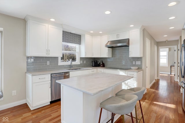 kitchen featuring sink, white cabinetry, stainless steel dishwasher, and a center island