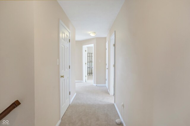 hallway featuring light carpet