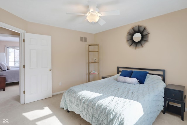 bedroom featuring ceiling fan and light carpet