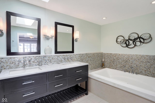 bathroom featuring a bathing tub, tile patterned floors, and vanity