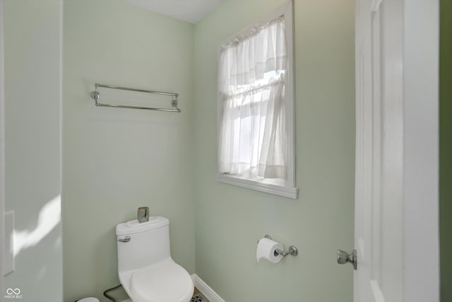 bathroom featuring toilet and a healthy amount of sunlight