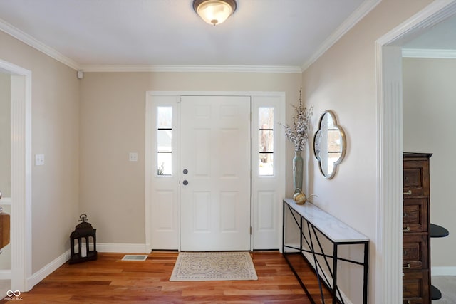 entrance foyer with wood-type flooring, plenty of natural light, and crown molding