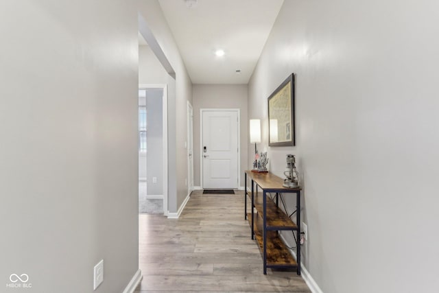 corridor with light wood-type flooring