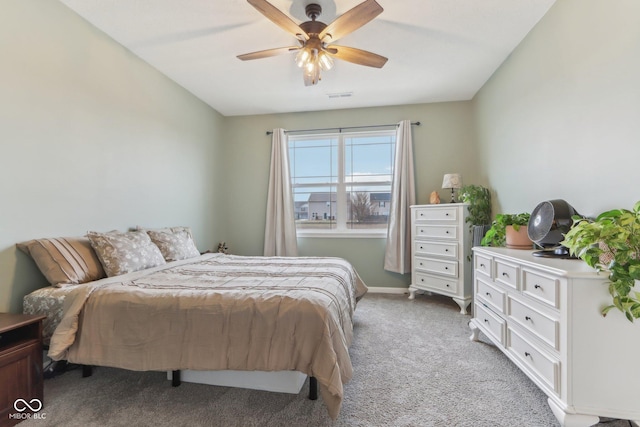 bedroom with ceiling fan, carpet flooring, and vaulted ceiling