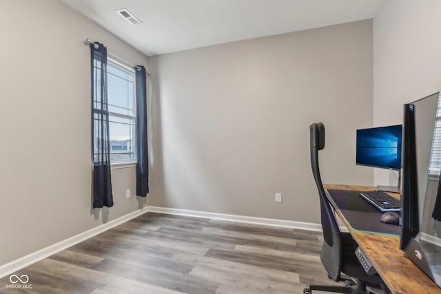 unfurnished office featuring hardwood / wood-style floors