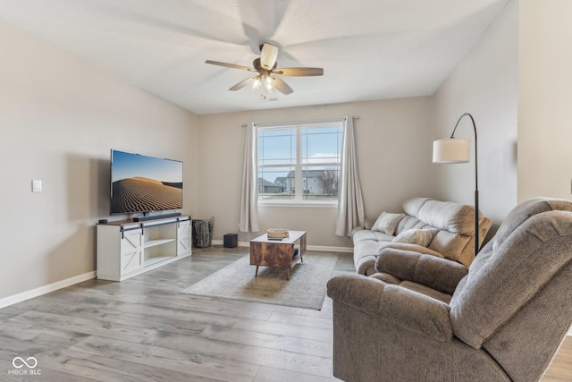 living room with ceiling fan and light wood-type flooring