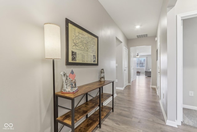 hallway with hardwood / wood-style flooring