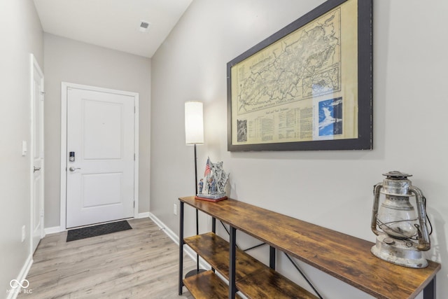 foyer entrance with light hardwood / wood-style flooring