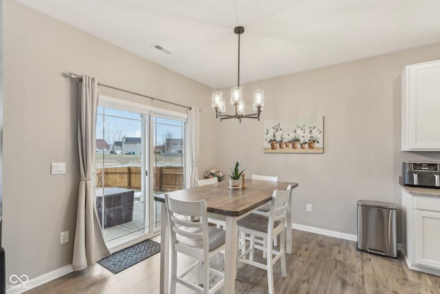 dining room with an inviting chandelier and light hardwood / wood-style floors