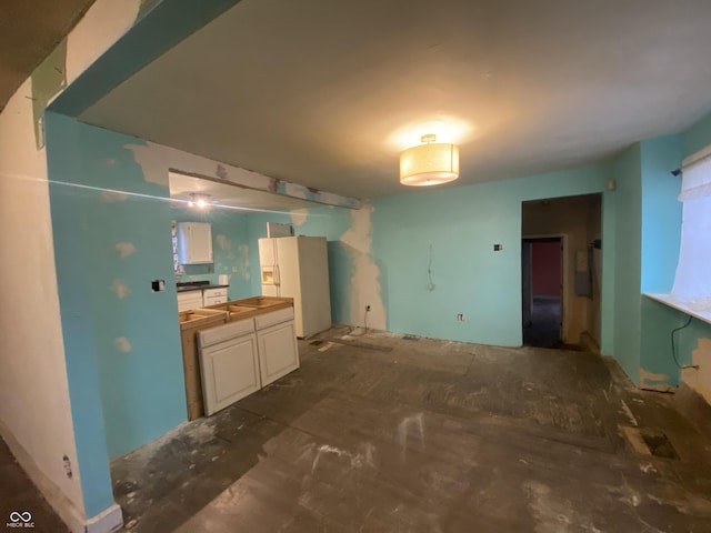 kitchen featuring white fridge with ice dispenser