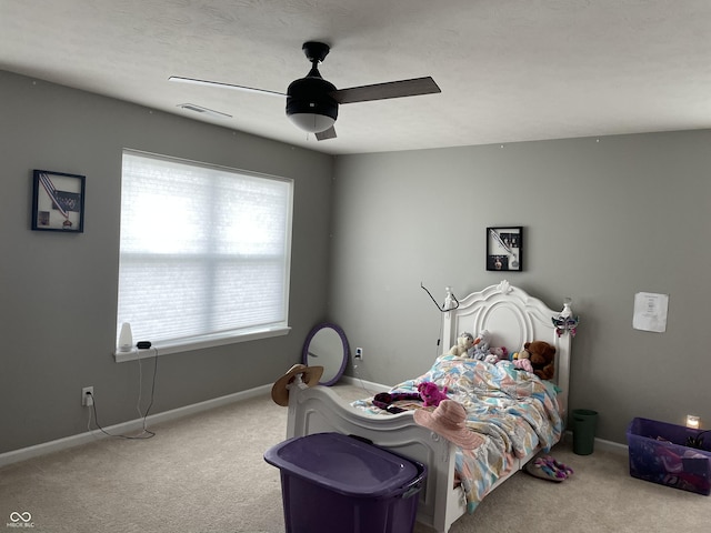 bedroom featuring light colored carpet and ceiling fan