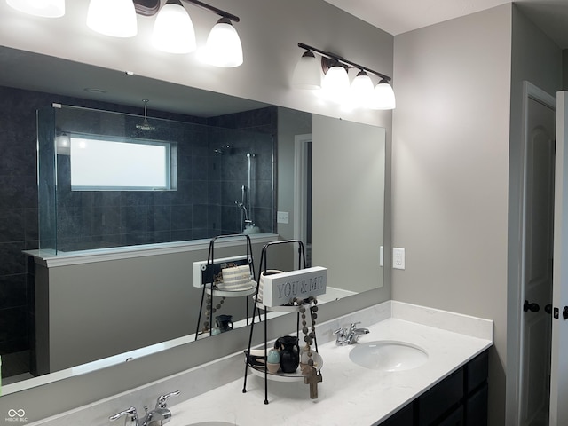 bathroom with vanity and tiled shower