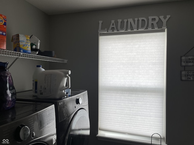 clothes washing area featuring separate washer and dryer