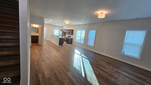 unfurnished living room with dark hardwood / wood-style floors