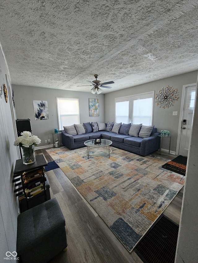 living room featuring wood-type flooring and ceiling fan