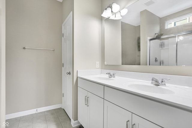 bathroom featuring tile patterned flooring, vanity, and walk in shower