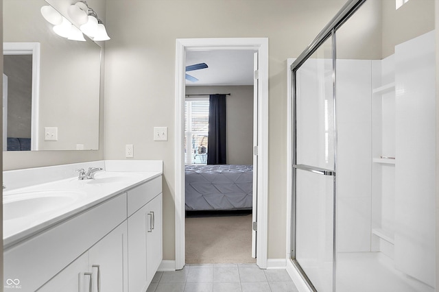 bathroom with tile patterned flooring, vanity, and an enclosed shower