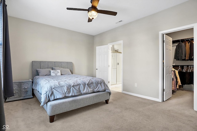 carpeted bedroom featuring a spacious closet, a closet, and ceiling fan