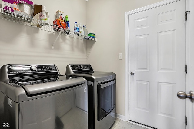 laundry area with light tile patterned floors and independent washer and dryer