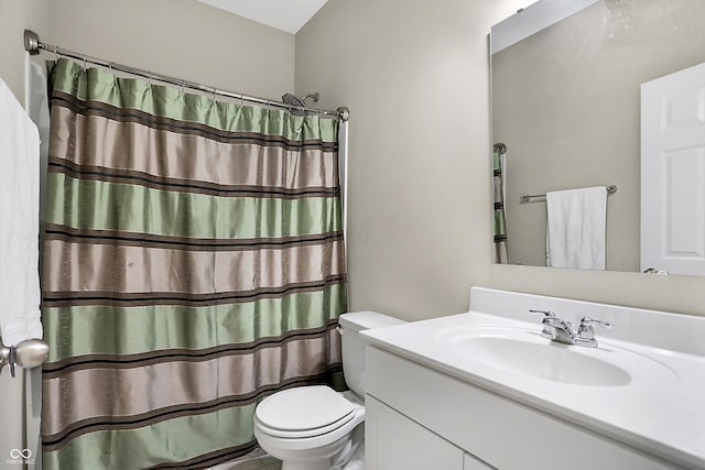 bathroom featuring vanity, a shower with shower curtain, and toilet