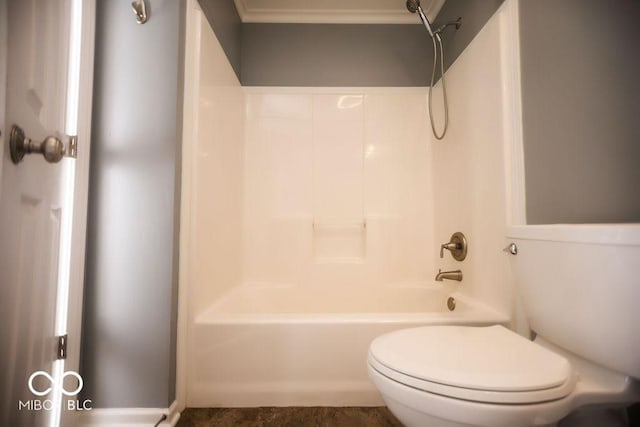 bathroom featuring crown molding, bathing tub / shower combination, and toilet