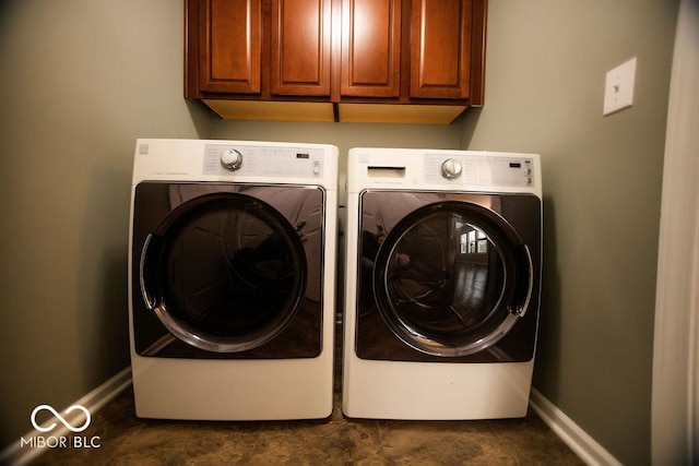 laundry area with cabinets and washing machine and clothes dryer