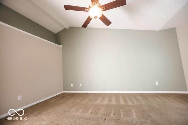 carpeted spare room with vaulted ceiling with beams and ceiling fan