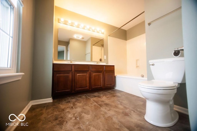 full bathroom featuring vanity, toilet, and washtub / shower combination