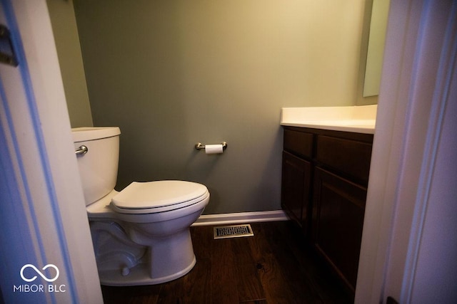 bathroom featuring vanity, hardwood / wood-style floors, and toilet