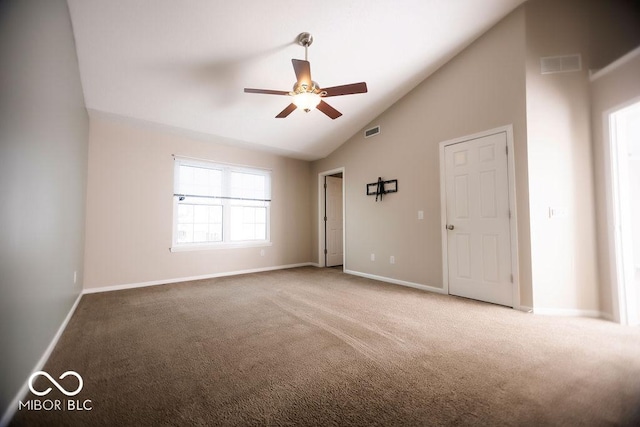 carpeted empty room with ceiling fan and lofted ceiling