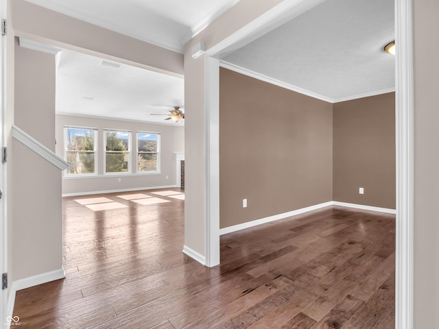 interior space with hardwood / wood-style flooring, ornamental molding, and ceiling fan