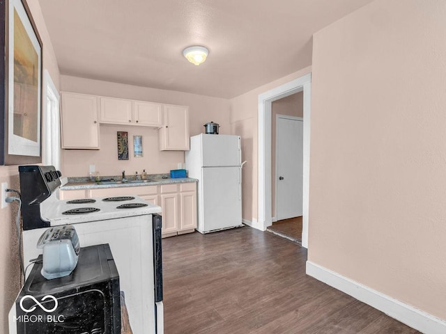 kitchen with dark wood-type flooring, sink, white cabinetry, electric range oven, and white fridge