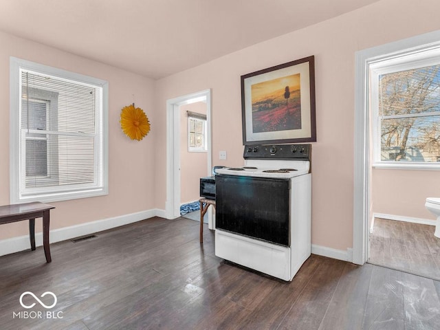 interior space featuring dark hardwood / wood-style floors and electric range