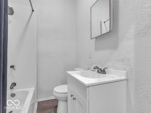 bathroom with hardwood / wood-style flooring, vanity, and toilet