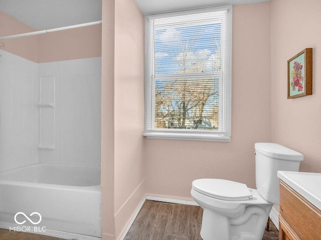 full bathroom with wood-type flooring, bathing tub / shower combination, vanity, and toilet