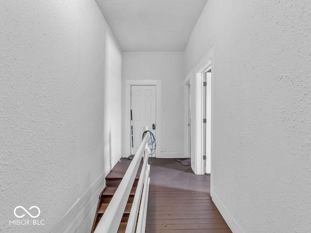 corridor with dark hardwood / wood-style flooring