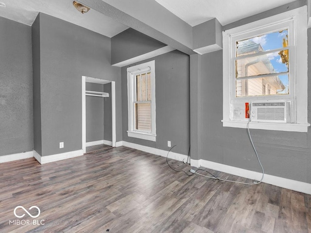 interior space with cooling unit and dark hardwood / wood-style floors