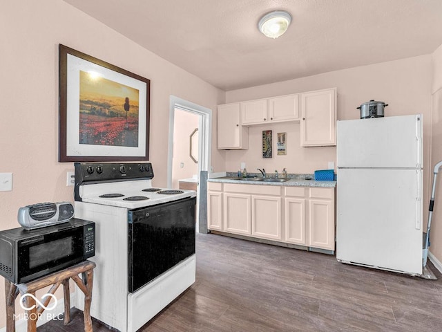 kitchen featuring white cabinetry, white appliances, dark hardwood / wood-style floors, and sink