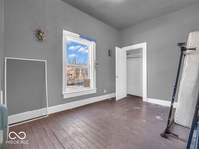 unfurnished bedroom with dark hardwood / wood-style floors