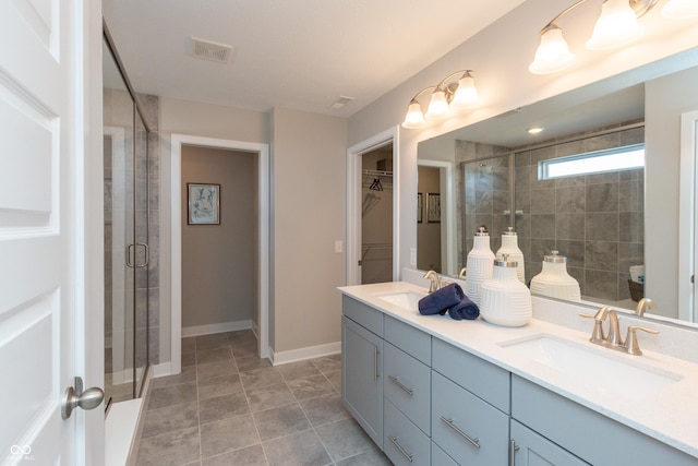 bathroom with vanity and a shower with shower door