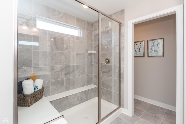 bathroom with tile patterned floors and a shower with shower door