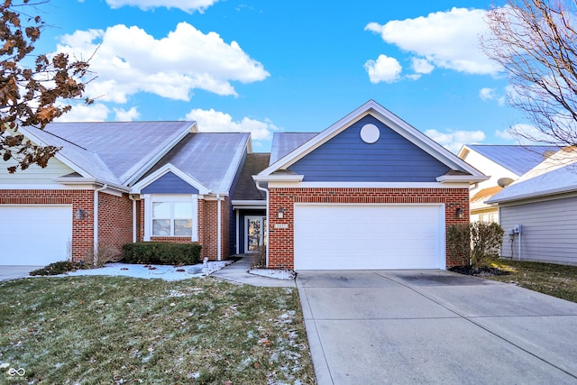 view of front of home with a garage and a front lawn