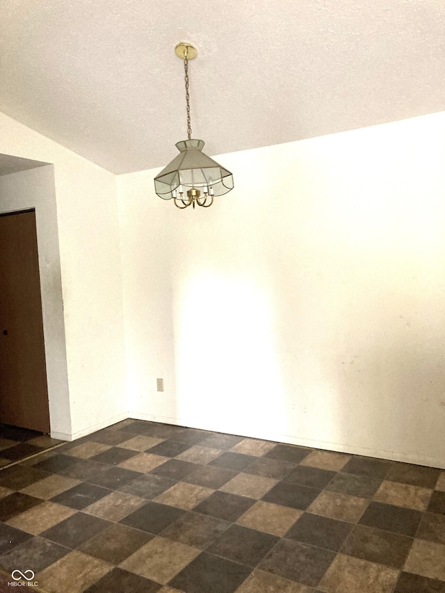 unfurnished room featuring lofted ceiling