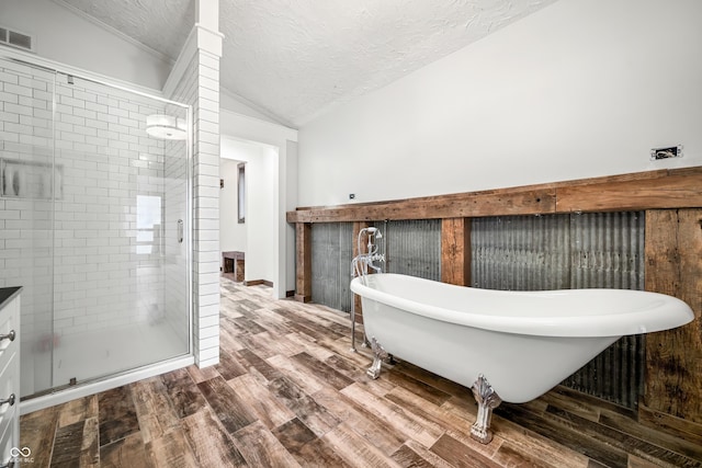 bathroom featuring hardwood / wood-style floors, a textured ceiling, shower with separate bathtub, and lofted ceiling