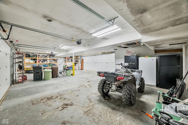 garage with white refrigerator and black fridge