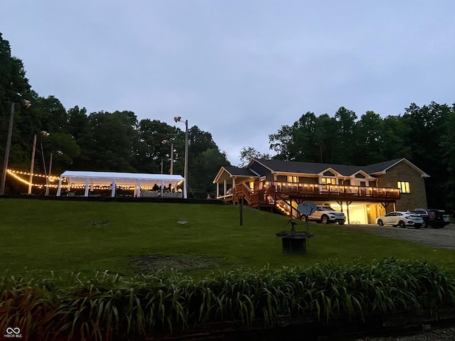 view of front of property featuring a front yard and a wooden deck